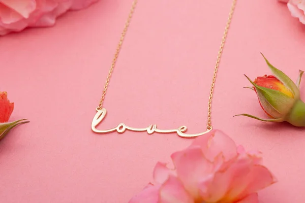 Still life jewelry picture for online sale. Photo of a silver necklace on a pink floral background that we can use in e-commerce, online sales, and social media.