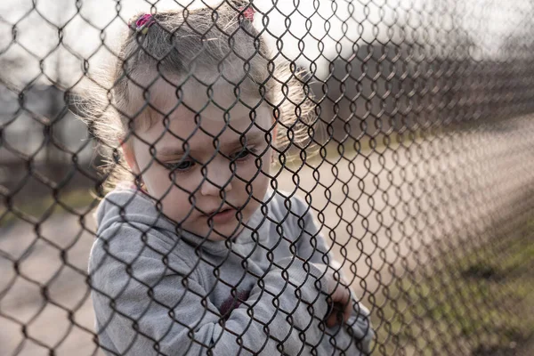 Little Girl Sad Look Metal Fence Social Problem Refugees Forced — Stock Fotó