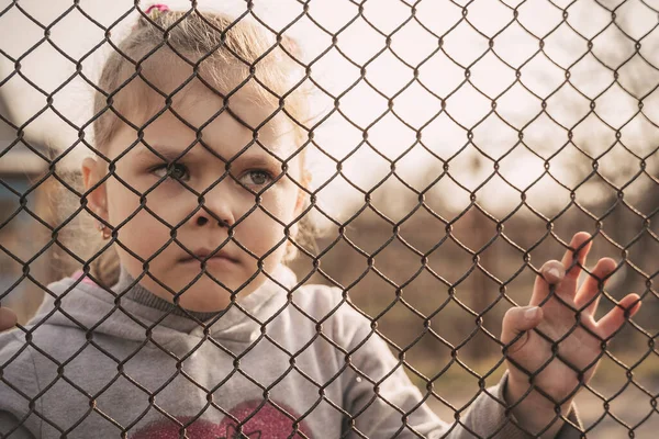 Egy Kis Menekült Lány Szomorú Tekintettel Fémkerítés Mögött Menekültek Lakóhelyüket — Stock Fotó