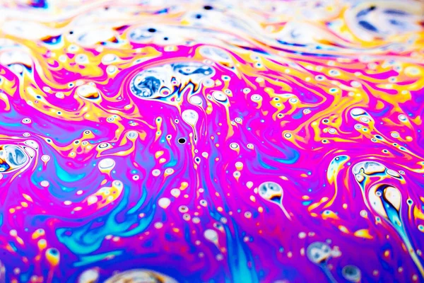 Beautiful psychedelic abstraction formed by light on the surface of a soap bubble.