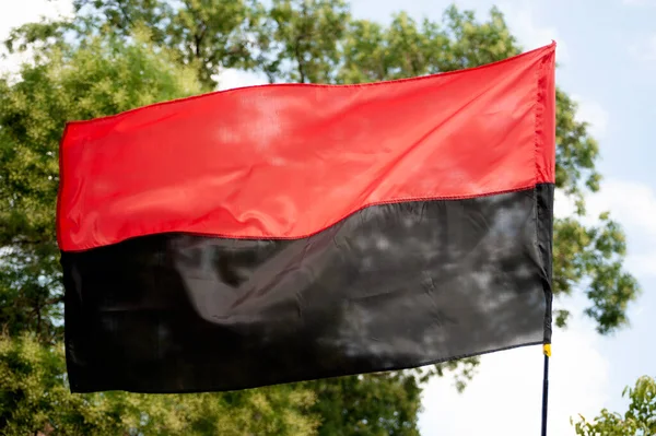 The two-striped red and black battle flag of the Ukrainian insurgent army of the forties of the last century is still in battle formation on the fronts of Ukraine alongside the state blue and yellow flag