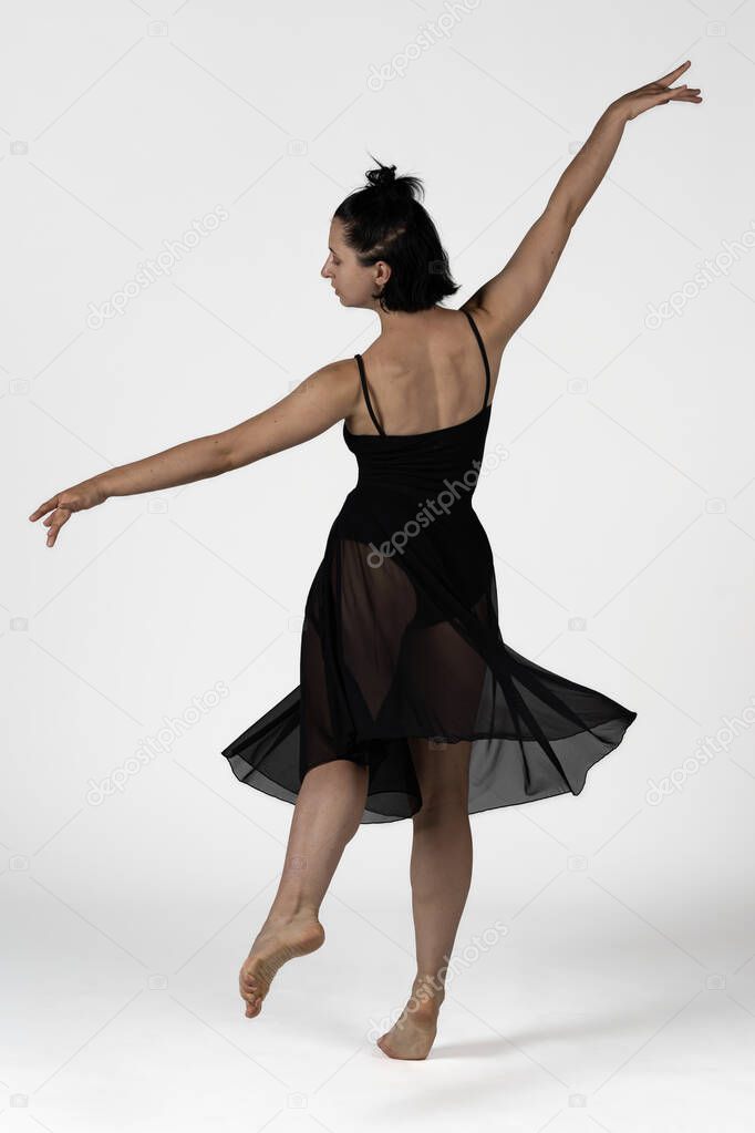 studio photo. Studio shot of a young woman dancer with black body dancing