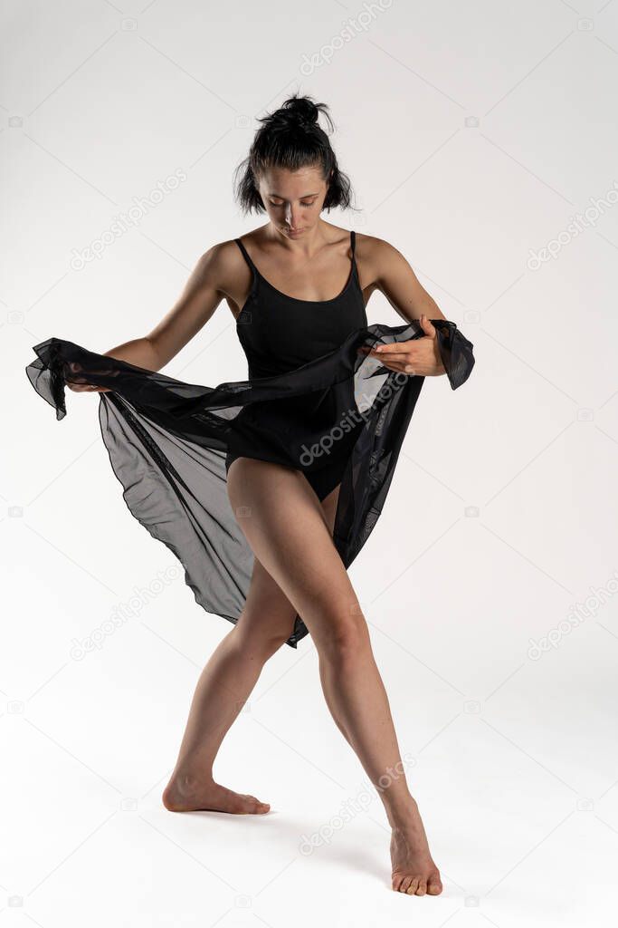 studio photo. Studio shot of a young woman dancer with black body dancing