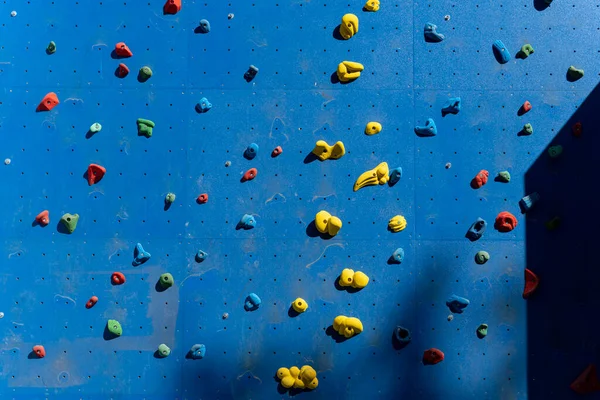 A blue climbing with colored plugs on the quays of the Bassin de la Villette