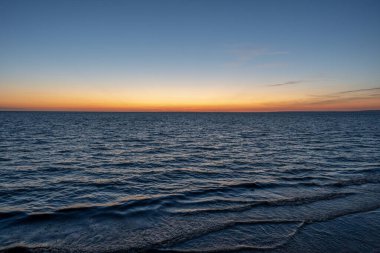 Sunrise over the sea from the beach and Le Havre far away