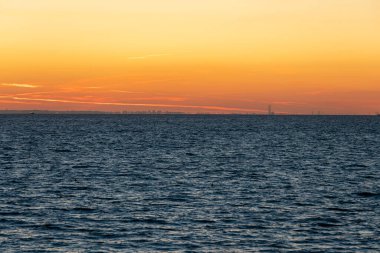 Sunrise over the sea from the beach and Le Havre far away