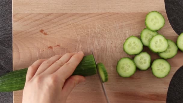 雌性手在木板上切碎新鲜黄瓜 厨房桌子上的黄瓜片 顶部视图 Close — 图库视频影像