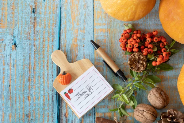 Thank You, LORD, a handwritten text note on a rustic wooden background with autumn fruit. Top table view. Copy space. Christian thanksgiving day, gratitude, and praise to God concept.