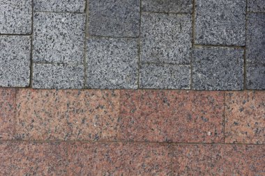 Brown-gray granite pavement. Pavement texture background.