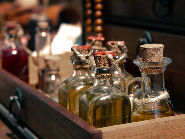 medieval reenactment - small bottles of tinctures, medicines or scented oils on the counter of a medieval apothecary merchant