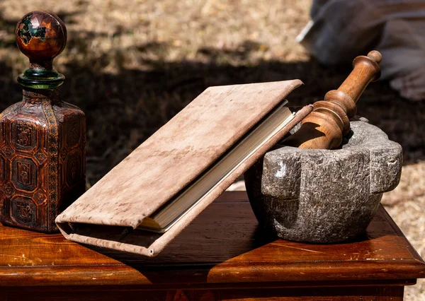 Medieval Reenactment Stone Mortar Pestle Wooden Table Book Royaltyfria Stockfoton