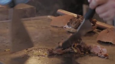 cooking pulled pork on a hot grill greased with oil and preparing sandwich