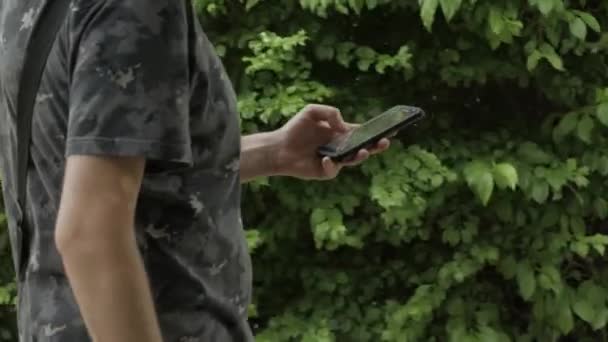 Side Shot Young Man Walking Park Using Mobile Phone — Wideo stockowe