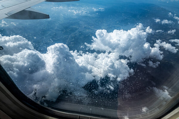 View of sky and clouds through the airplane window.