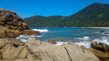 Woman looking at Cachadao beach in Paraty, Rio de Janeiro.