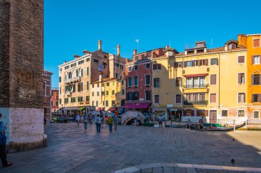 VENICE, ITALY - August 27, 2021: Beautiful view of Venice's canals with tourists strolling through its streets.