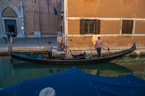VENICE, İtalya - 27 Ağustos 2021: Venedik kanallarından gondola giren çift görüntüsü.