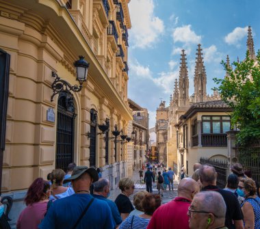 GRANADA, SPAIN - SEPTEMBER 25, 2021: View of people strolling through the historic center of Granada near the Cathedral