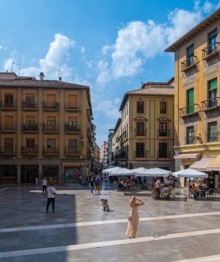 GRANADA, SPAIN - SEPTEMBER 25, 2021: View of beautiful woman posing in square around Granada Cathedral