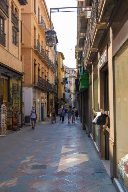 GRANADA, SPAIN - SEPTEMBER 25, 2021: View of people strolling through the historic center of Granada near the Cathedral