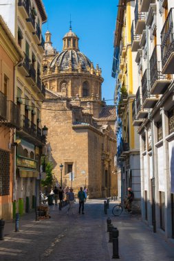 GRANADA, SPAIN - SEPTEMBER 25, 2021: View of tourists on streets of Granada with a church on background.