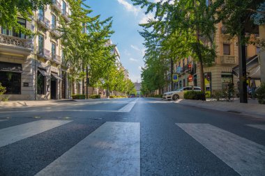 GRANADA, SPAIN - SEPTEMBER 25, 2021: Beautiful view of the main avenue of the city of Granada Gran Va de Coln