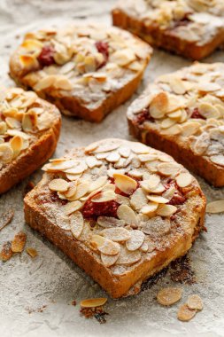Badem kreması (frangipan) ve fırında pişmiş Brioche dilimlerinden yapılmış ahududu eklenmiş Bostock, yakın görüş. Geleneksel Fransız tostu.. 