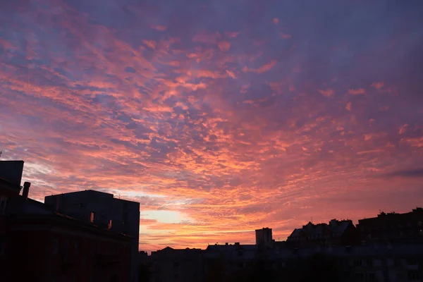 the setting sun highlights the clouds over the city