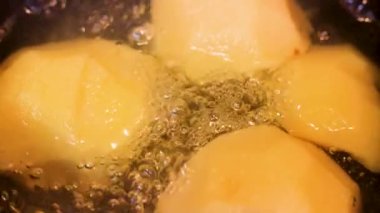 Slow motion, preparing a delicious syrup of quinces or peaches boiling in water with sugar, many bubbles are seen