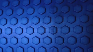 hexagonal texture in blue with a gradient towards black from a massage foam roller