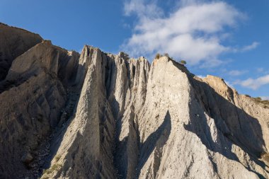 mountainous landscape in the south of Spain, it is a steep area, there are bushes, there are clouds in the sky