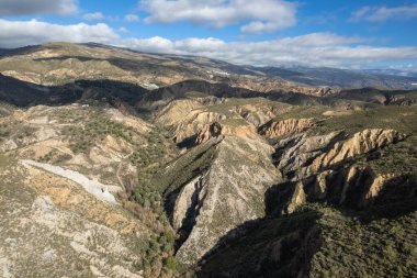 İspanya 'nın güneyindeki dağlık arazide birçok vadi var. Gökyüzünde bulutlar var.
