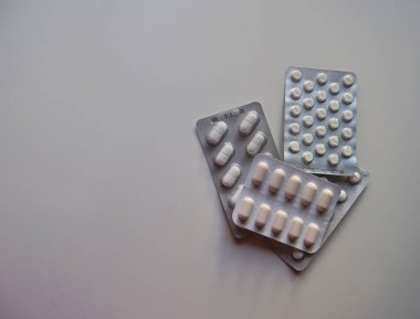 İlaç kutuları beyaz haplar ve kapsüller içinde.