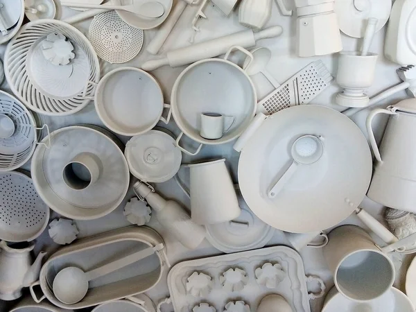 White painted kitchen utensils decorating the wall