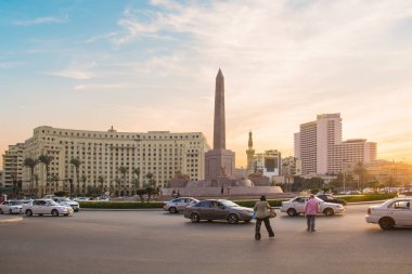 CAIRO, EGYPT - DECEMBER 29, 2021: The Obelisk of Ramses II is surrounded by four ancient sandstone sphinxes in Cairo, Egypt