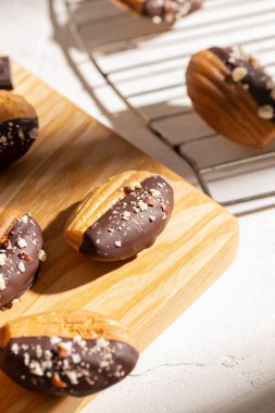 Vanilla madeleine cookies with chocolate and nuts