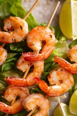 Freshly cooked grille shrimps with letucce on a plate