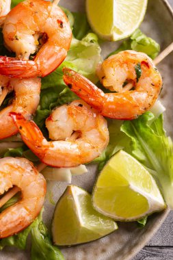 Freshly cooked grille shrimps with letucce on a plate