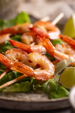 Freshly cooked grille shrimps with letucce on a plate