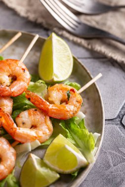 Freshly cooked grille shrimps with letucce on a plate