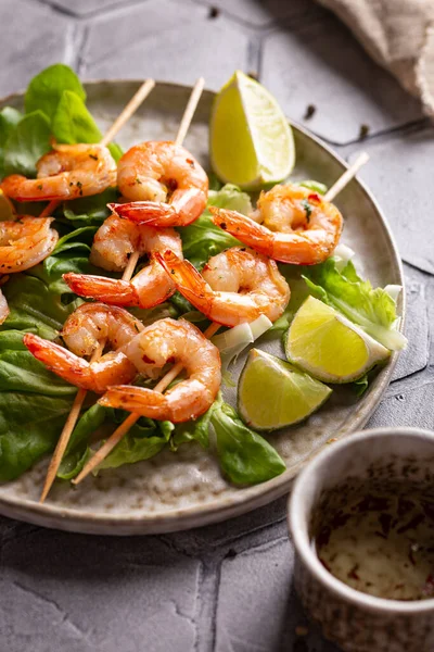 Freshly cooked grille shrimps with letucce on a plate