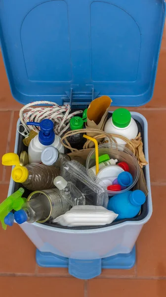 Home Recycling Bin with lid before sorting glass, plastic, paper, metal into separate recycling containers. Isolated on a brown background. Close-up.Copy space.  Garbage recycling concept.