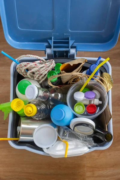 Home Recycling Bin with lid before sorting glass, plastic, paper, metal into separate recycling containers. Isolated on a brown background. Close-up.Copy space.  Garbage recycling concept.