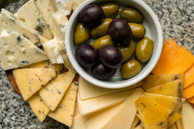 Top view of cheese and olives varieties