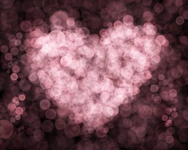 Kalpte bulanık pembe baloncuklar ya da sevgililer günü ya da düğün afişi için aşk şekli