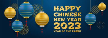 Chinese new year 2023 of the rabbit with realistic, rose gold and bkue baubles. China gold gradient text. Golden hare on a blue background. Vector illustration