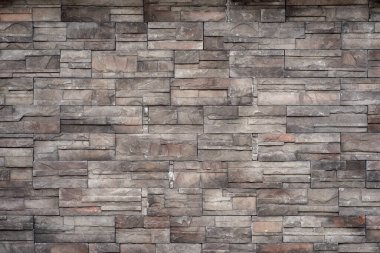 Tuğla ve taştan yapılmış duvar. Gri taş desenli duvar.