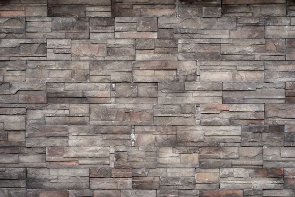 Tuğla ve taştan yapılmış duvar. Gri taş desenli duvar.