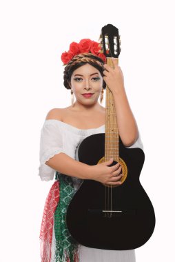 Mexican woman made up with Mexican flag colors wearing white dress. Mexican woman with guitar on white background.