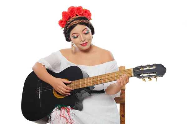 Mexican woman made up with Mexican flag colors wearing white dress. Mexican woman with guitar on white background.